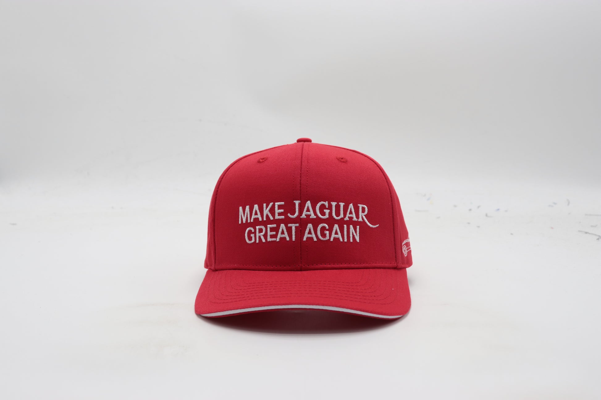 Red cap with 'MAKE JAGUAR GREAT AGAIN' text on a white background