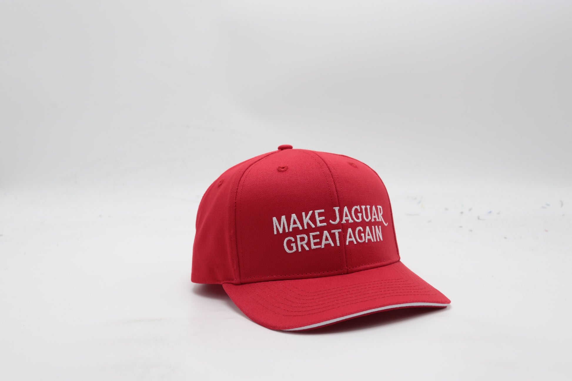 Red cap with 'MAKE JAGUAR GREAT AGAIN' text on a white background