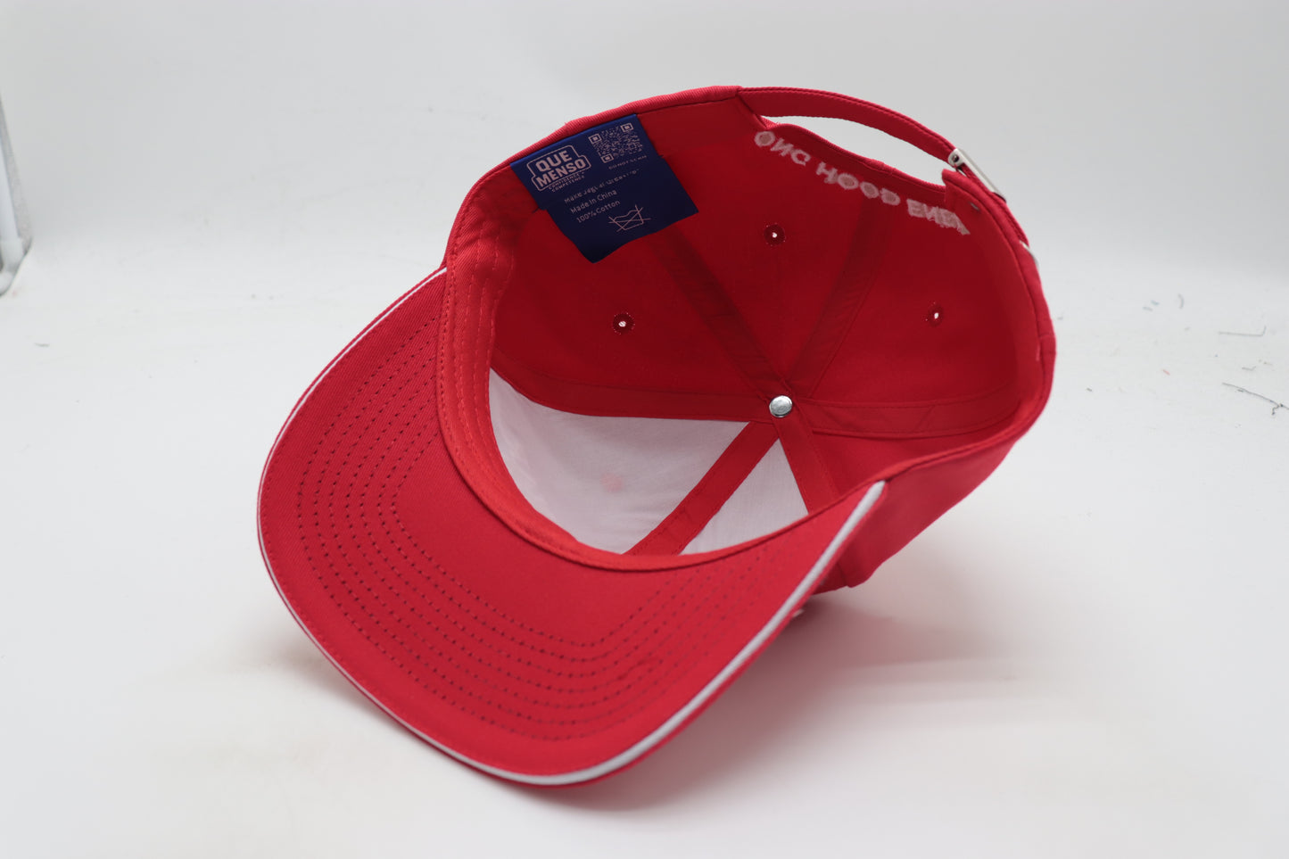 Red cap with a brand logo on a white background